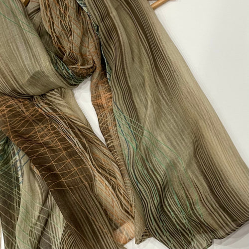 The Beige Printed Hijab adds a touch of sophistication to any outfit. Crafted from a delicate, light fabric, this hijab has an abstract print featuring hints of teal and orange to add a subtle but eye-catching detail. Perfect for any special occasion.