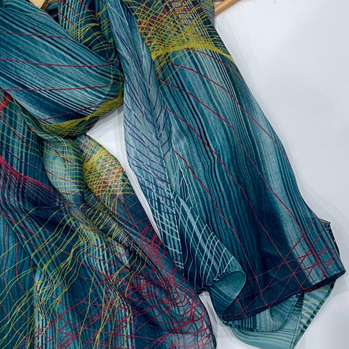 This gorgeous teal hijab features a beautiful abstract print with touches of lemon yellow and pink - perfect for adding a pop of color to any outfit. Its comfortable design and lightweight fabric make it ideal for daily wear.